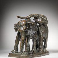 Alt text: Bronze sculpture of a pair of elephants leaning against one another, angled view