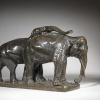 Alt text: Bronze sculpture of a pair of elephants leaning against one another, angled view