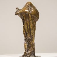Alt text: Bronze sculpture of a woman draped in fabric revealing her face and chest