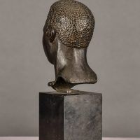 Alt text: Bronze bust of the head of a boxer