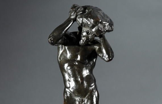 Alt text: Bronze sculpture of a nude figure holding a rock above his head