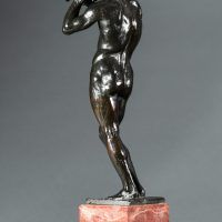 Alt text: Bronze sculpture of a nude figure holding a rock above his head