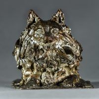 Alt text: Bronze sculpture of a pomeranian