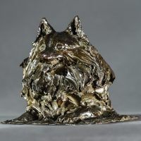 Alt text: Bronze sculpture of a pomeranian