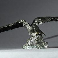 Alt text: Bronze sculpture of an eagle with outstretched wings