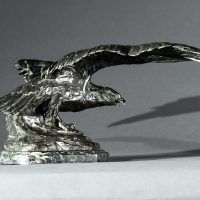 Alt text: Bronze sculpture of an eagle with outstretched wings