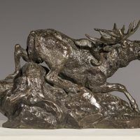 Alt text: Bronze sculpture of an Eland, or antelope, being surprised by a lynx attack on its back haunch