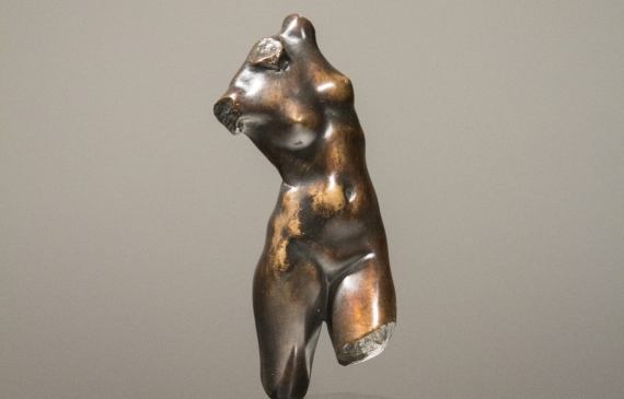 Alt text: Bronze sculpture of a twisting female torso