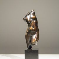 Alt text: Bronze sculpture of a twisting female torso