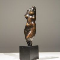 Alt text: Bronze sculpture of a twisting female torso