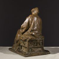 Alt text: Bronze sculpture of a mother tending to the baby seated on her lap