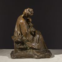 Alt text: Bronze sculpture of a mother tending to the baby seated on her lap