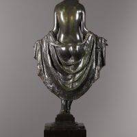 Alt text: Bronze sculpture of a nude woman holding a piece of fabric behind her