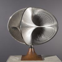 Alt text: Abstract sculpture with warped geometric shapes that create an optical illusion