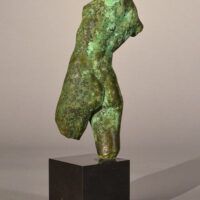 Alt text: Bronze sculpture of a torso
