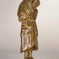 Alt text: Bronze sculpture of a young woman carrying her baby in 1910s clothing, angled view