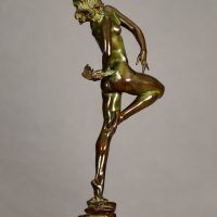 Alt text: Bronze sculpture of a nude woman skipping and holding a fish in one hand