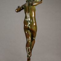 Alt text: Bronze sculpture of a nude woman posing with hands up