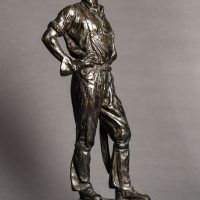 Alt text: Bronze sculpture of a telephone linesman in work gear