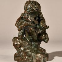 Alt text: Bronze sculpture of a bear catching an owl in his maw