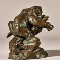 Alt text: Bronze sculpture of a bear catching an owl in his maw