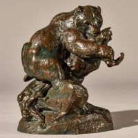 Alt text: Bronze sculpture of a bear catching an owl in his maw