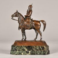 Alt text: Bronze sculpture of a warrior on horseback atop a marble base