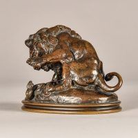 Alt text: Bronze sculpture of a lion fighting a serpent