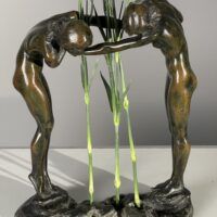 Alt text: Bronze sculpture of two figures holding hands
