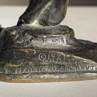 Alt text: Bronze sculpture, signature detail