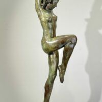 Alt text: Bronze sculpture of a standing woman