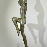 Alt text: Bronze sculpture of a standing woman