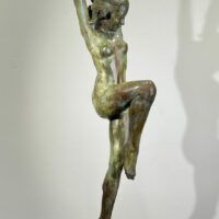 Alt text: Bronze sculpture of a standing woman