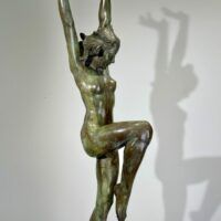 Alt text: Bronze sculpture of a standing woman