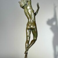 Alt text: Bronze sculpture of a standing woman