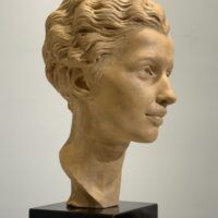 Alt text: Terracotta bust of a young woman's face
