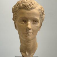 Alt text: Terracotta bust of a young woman's face