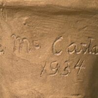 Alt text: Terracotta sculpture, signature detail
