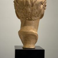 Alt text: Terracotta bust of a young woman's head