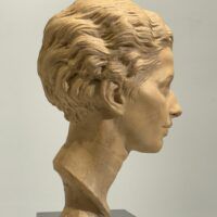 Alt text: Terracotta bust of a young woman's face