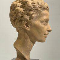 Alt text: Terracotta bust of a young woman's face