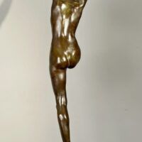 Alt text: Bronze sculpture of a standing woman