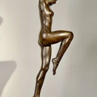 Alt text: Bronze sculpture of a standing woman