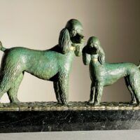 Alt text: Bronze sculpture of two poodles