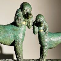 Alt text: Bronze sculpture of two poodles