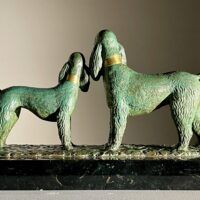 Alt text: Bronze sculpture of two poodles