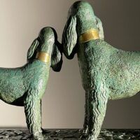 Alt text: Bronze sculpture of two poodles