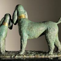 Alt text: Bronze sculpture of two poodles