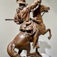 Alt text: Bronze sculpture of a man on a horse