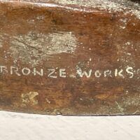 Alt text: Bronze sculpture, foundry mark